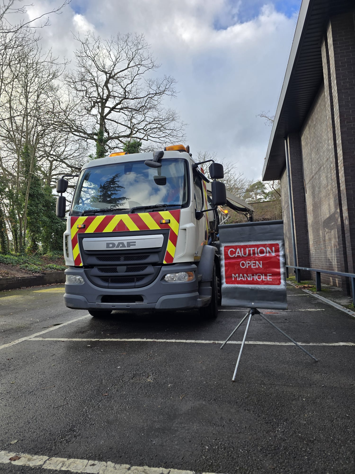 DAF tanker on site with open manhole warning sign