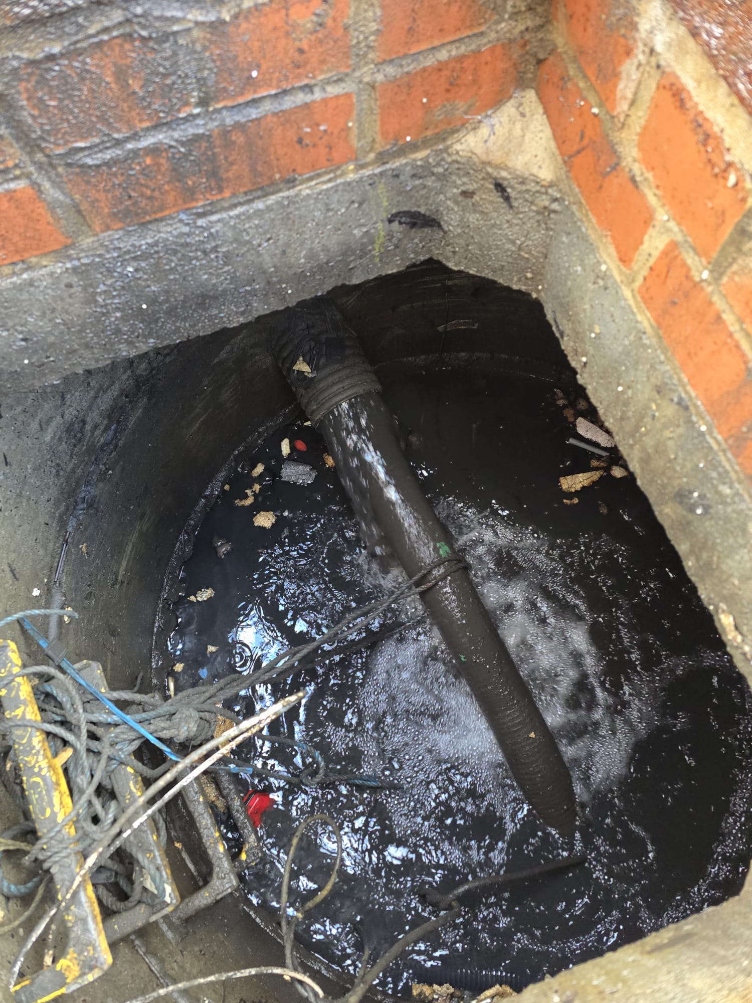 Brick manhole with pipe discharging into chamber