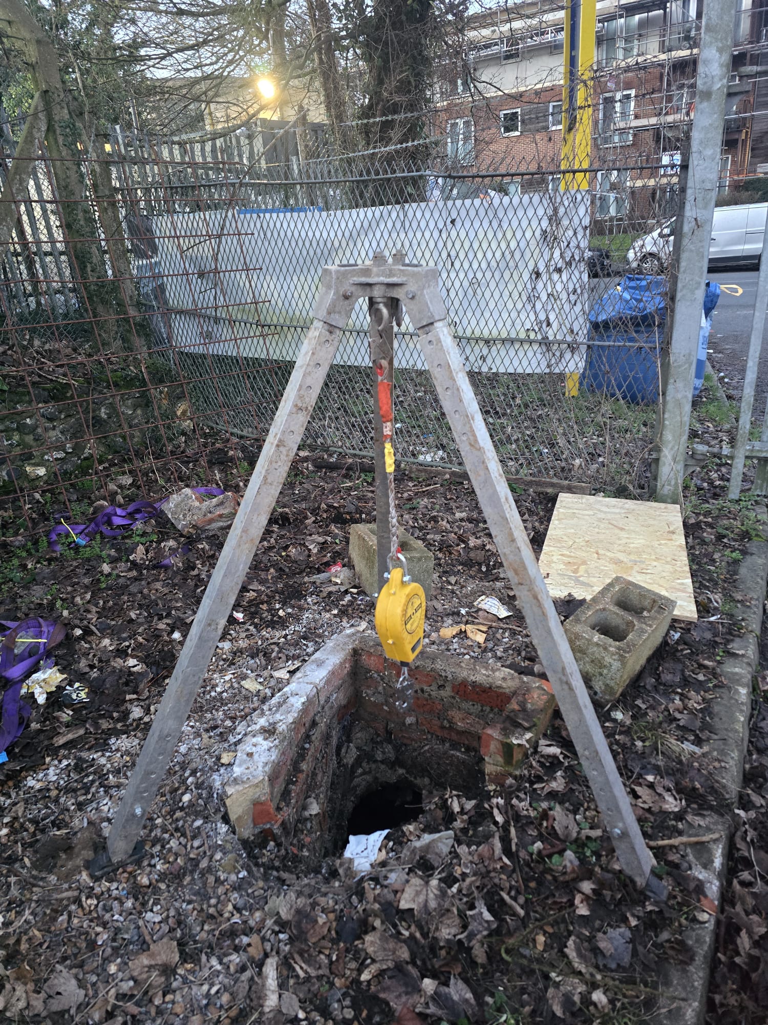 Tripod rigged over brick manhole