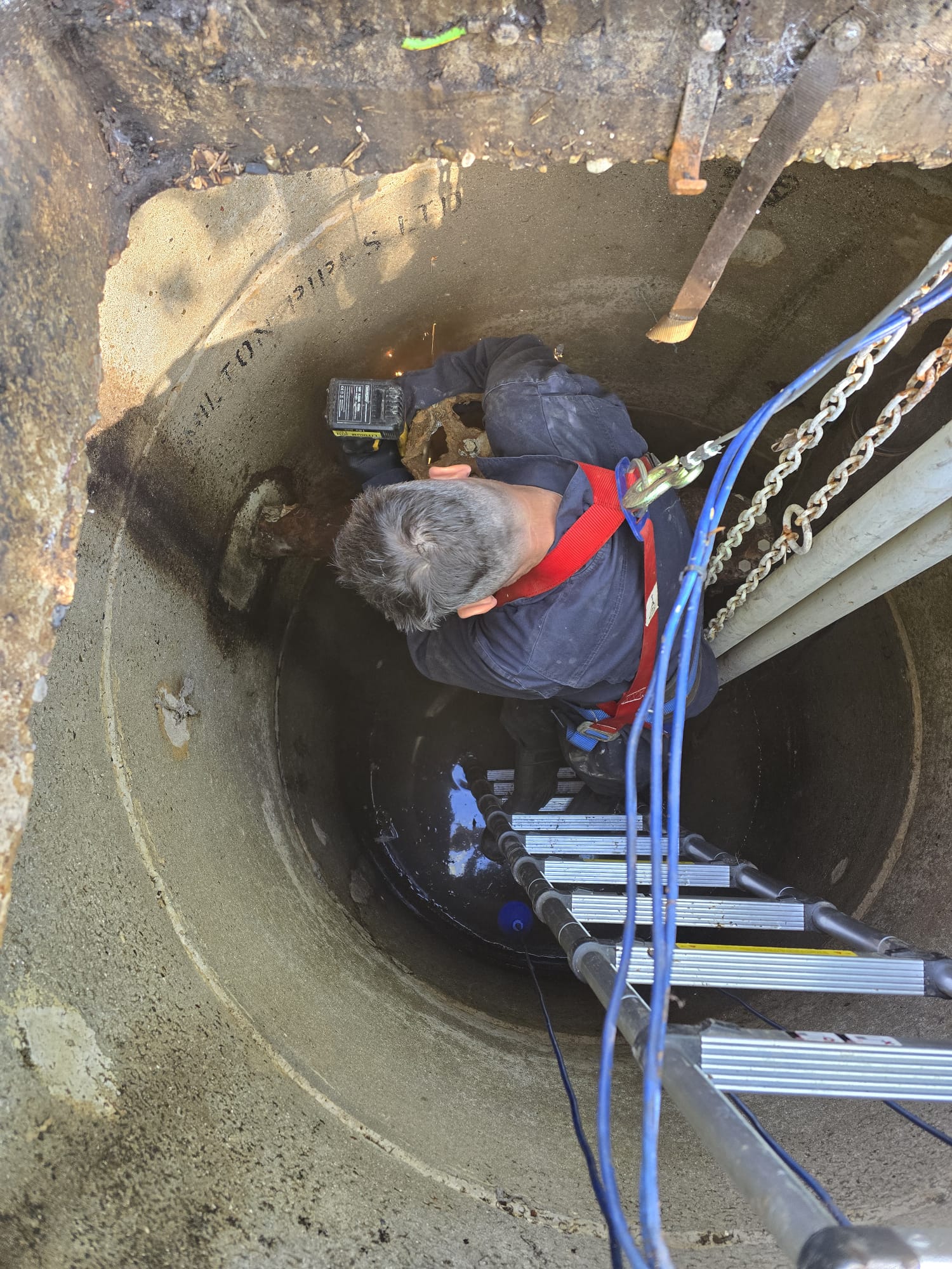 Engineer servicing pump in chamber
