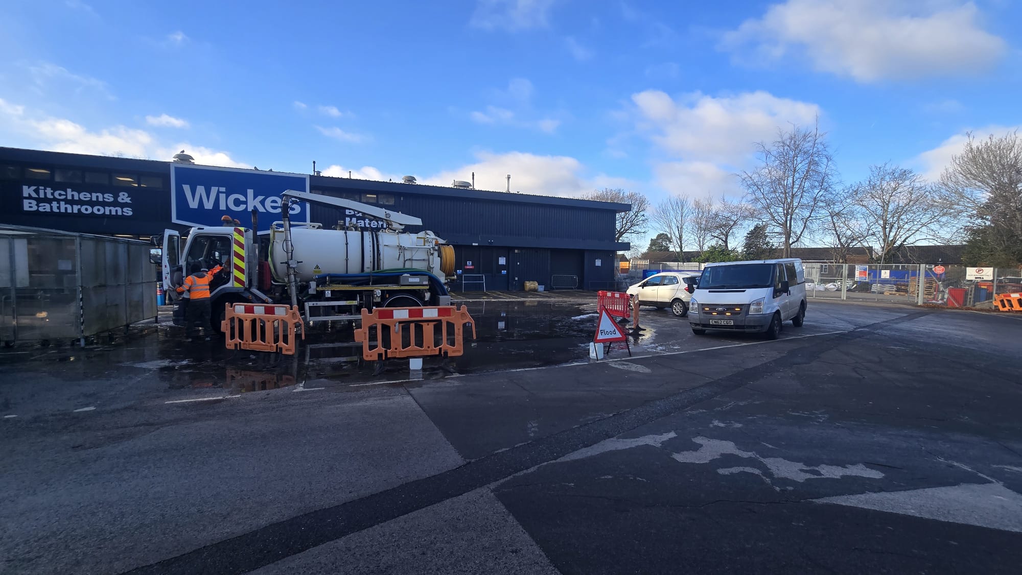 Jet-vac tanker clearing flooded forecourt at Wickes
