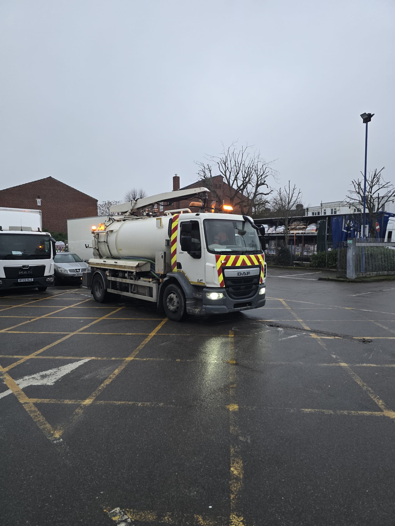 Linear channel drain alongside tanker on car park