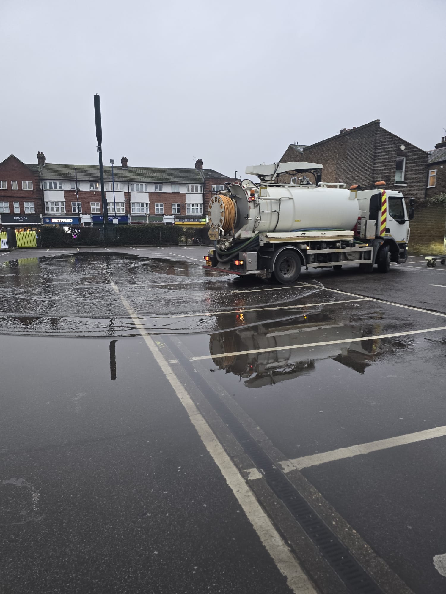 Tanker discharging into flooded car park